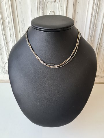 Three-row necklace in oxidised and gilded sterling silver