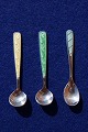 Salt spoon of Danish sterling silver with green 
enamel L 6cms (spoon to the right)