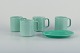 Royal Copenhagen, 4 All Seasons, four coffee mugs and a small oval dish in faience with green glaze.