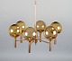 Sv. Mejlstrøm, Danish designer. Brass chandelier with six arms and dome-shaped shades made of amber-colored glass.