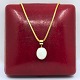 A necklace set with an opal mounted in 18k gold