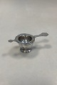 Danam Antik 
presents: 
ABSA Tea 
Strainer with 
holder in 
silver plated
