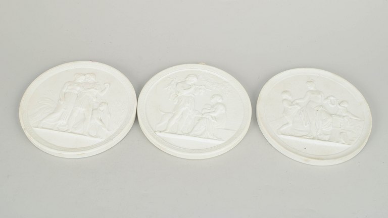 Royal Copenhagen, set of three biscuit wall plaques after Thorvaldsen.