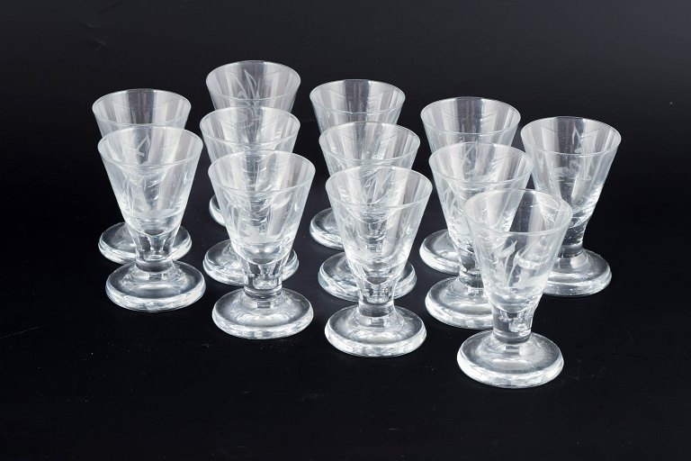 Scandinavian glassworks, set of twelve schnapps glasses with duck and reed motif.